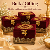 Group shot displaying four matching royal maroon velvet gift boxes arranged together on a polished brass tray to showcase bulk order capability, ideal for luxury wedding return gifts, Diwali festive gifting, bridal favours, and corporate event giveaways, each box featuring detailed gold embroidery on top, an antique brass clasp lock, and an ornate golden base trim.