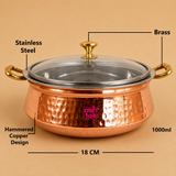 1000ml hammered copper and stainless steel serving handi with transparent glass lid, brass knob, brass handles, and 18 cm diameter, ideal for serving biryani, curries, rice, and traditional Indian dishes at home, hotels, and restaurants.