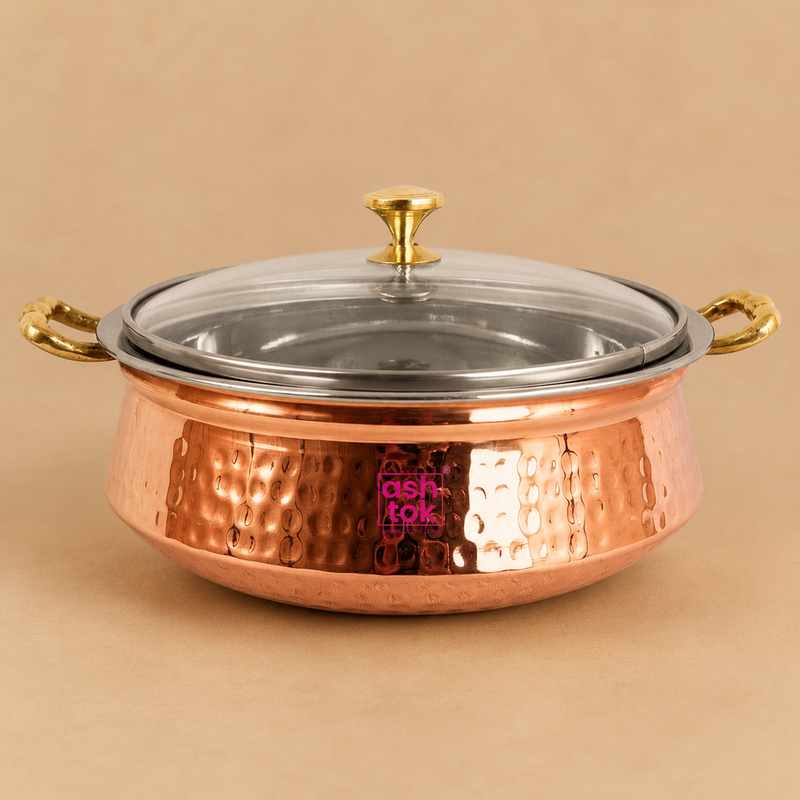 Hammered copper and stainless steel serving handi with transparent glass lid and brass handles, ideal for serving biryani, curries, rice, and traditional Indian dishes at home, restaurants, and catering.