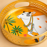 Detailed close-up view of Cow Design Tray Flower Basket and Puja Tray for Temple highlighting the traditional white cow artwork, palm tree motifs, vibrant golden base, polished rim, decorative cutwork side pattern and practical carry opening. The close-up emphasizes the tray’s fine decorative detailing, bright finish and traditional design for puja, gifting and temple use.