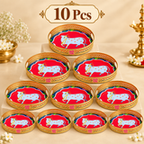 Set of 10 Cow Design Tray Flower Basket and Puja Tray for Temple arranged in a premium beige bulk gifting display. Each tray features a polished golden rim with decorative cutwork, round shape, sacred cow center artwork and visible ASHTOK logo, making this set suitable for festive gifting, religious events, wedding return gifts, temple functions, family ceremonies and bulk gift orders.