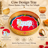 Features image of Cow Design Tray Flower Basket and Puja Tray for Temple highlighting the premium golden brass-look finish, decorative cutwork rim, sacred cow artwork, side carry openings and traditional round tray design. The image presents the tray in a clean beige studio setting with clearly visible ASHTOK logo, showing its suitability for temple use, flower offerings, prasad serving, festive rituals and devotional gifting.