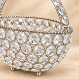 Detailed close-up view of Crystal Basket German Silver decorative flower and fruit basket highlighting the clear faceted crystal stones, polished circular German silver framework, twisted rope-style rim, crystal-studded handle attachment, reflective finish and fine decorative craftsmanship, showing the sparkling texture and premium detailing of the basket for home decor and gifting use.