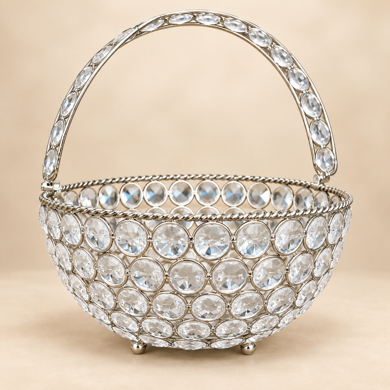 Crystal Basket German Silver flower basket and fruit basket for home decor featuring a round decorative basket with sparkling clear crystal-studded design, polished German silver finish, ornamental crystal handle, twisted rim detailing and small rounded feet, professionally photographed on a premium warm beige studio background for elegant home decoration, gifting, fruit serving, flower presentation and decorative display.