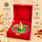 Open meenakari kumkum box with hinged lid on a decorative pooja thali, shown from an angled view on a beige background