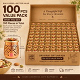 Bulk pack presentation of 100 decorative dry fruit gift jar boxes arranged securely in a large organized carton for wholesale, event and large-scale gifting requirements. The image shows multiple matching copper-toned jars packed in individual sections, each featuring intricate floral cutwork, a smooth rounded body and a decorative golden lid topped with layered flower petals and a round knob. 