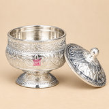 Open German Silver Kumkum Holder with the ornate domed floral engraved lid removed and placed beside the container, clearly showing the smooth reflective inner storage area, rounded engraved body, decorative leaf and flower patterns, polished silver-tone finish and short pedestal base, photographed on a premium beige studio background to demonstrate the removable lid and usable interior for storing kumkum, roli, sindoor, turmeric and other small traditional pooja essentials.