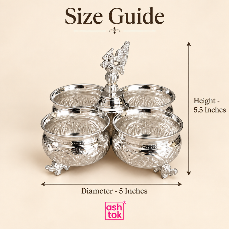 German silver chopala gift item with 4 attached bowls shown in a size guide format on a beige background, featuring measurement indicators for 5 inches diameter and 5.5 inches height, along with a decorative center finial, polished silver finish, embossed bowl detailing and ornamental feet, helping customers understand the overall size, proportions and display presence of this elegant gift item for festive use, return gifting, serving dry fruits and decorative table styling.