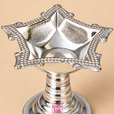 Close-up detail image of a German Silver Diya photographed on a warm beige studio background, focusing on the upper bowl and showing the reflective textured inner surface, square floral design, pointed corners, decorative beaded rim and the top portion of the ringed pedestal stem, helping customers closely view the fine craftsmanship, surface finish, ornamental detailing and premium traditional styling of the diya for devotional and decorative purposes.