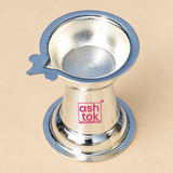 Top angle product image of a traditional German Silver Diya placed against a premium beige background, clearly showing the inner bowl shape, polished reflective interior, flared circular rim, side wick-holder extension, conical body and wide flared base, photographed in soft even lighting to display the design and proportions of the diya from above, useful for understanding the bowl depth and overall product styling for puja use, festive lighting and devotional settings.