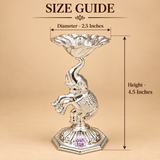 German Silver Elephant Pooja Diya size guide showing approximately 2.5 inch diameter and 4.5 inch height, featuring a raised flower shaped diya bowl with central wick holder, decorative elephant motif and embossed octagonal base, presented on a beige background with measurement arrows to help customers understand the compact size for home temple use, pooja rituals, festive decoration and gifting.