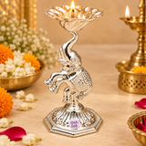 German Silver Elephant Pooja Diya displayed in a festive pooja setting with flowers, warm lighting and traditional decor elements, showing the polished silver elephant figure, elevated floral diya bowl and decorative base as an attractive piece for daily worship, home mandir decoration, Diwali celebrations, festive rituals, spiritual gifting and auspicious home use.