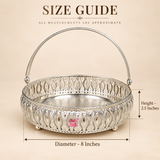 German Silver Flower Butti size guide showing approximately 8 inch diameter and 2.5 inch basket height, featuring a decorative round body with detailed floral cutwork, polished silver finish, engraved base, raised feet and an arched carrying handle, presented on a beige background to help customers understand the dimensions for gifting, festive decoration, pooja use and serving purposes.