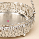 Top view of a German Silver Flower Butti showing the round engraved base with detailed floral and paisley inspired patterns, surrounding ornamental cutwork border and curved carrying handle, photographed against a clean beige studio background to clearly display the interior design and decorative craftsmanship for flower arrangements, pooja accessories, gifting and festive presentation.