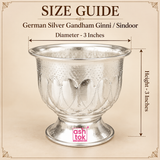Size guide image of a German Silver Gandham Ginni and Sindoor Holder showing approximately 3 inch diameter and 3 inch overall height with clear measurement arrows, while displaying the wide flared rim, rounded embossed bowl, decorative petal pattern, polished neutral silver finish and stable pedestal base on a premium beige background, helping customers understand the compact dimensions and overall proportions before purchasing for sindoor storage, gandham use, kumkum rituals, pooja ceremonies or traditiona