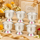 Multiple matching German Silver Gandham Ginni and Sindoor Holders arranged neatly in a premium festive gifting presentation with elegant beige and gold gift boxes, ribbon accents, flowers and traditional decorative elements, showcasing the polished silver finish, embossed petal design, flared rims and pedestal bases, suitable for wedding return gifts, housewarming favors, festive giveaways, pooja gifts, religious functions, family celebrations, corporate gifting and larger bulk order requirements.