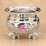 German silver Gandham Ginni bowl with a polished reflective finish, embossed decorative body, wide flared rim and elephant design legs, presented on a premium beige studio background for puja and traditional use.