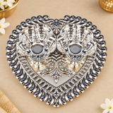 Front angle view of German Silver Haldi Kumkum Holder with two decorative flower-shaped bowls mounted on an ornate heart-shaped tray, showcasing the polished silver surface, traditional raised motifs, curved border detailing and compact ceremonial design for pooja, haldi kumkum rituals and festive use