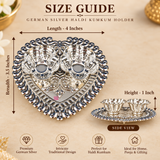 German Silver Haldi Kumkum Holder size guide showing approximately 4 inches length, 3.5 inches breadth and 1 inch height, with a heart-shaped decorative tray, two attached flower-pattern bowls, intricate traditional border design and polished silver finish for pooja, festive rituals and gifting