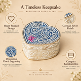 Feature presentation image of a German Silver Heart-Shaped Kumkum Box highlighting the heart-shaped design, polished German silver finish, decorative floral engraving and compact kumkum storage form, shown on a premium beige background with elegant feature callouts, while clearly displaying the intricately engraved lid, ornate side patterns and traditional styling suitable for daily pooja, wedding rituals, festive ceremonies, decorative gifting and religious use.