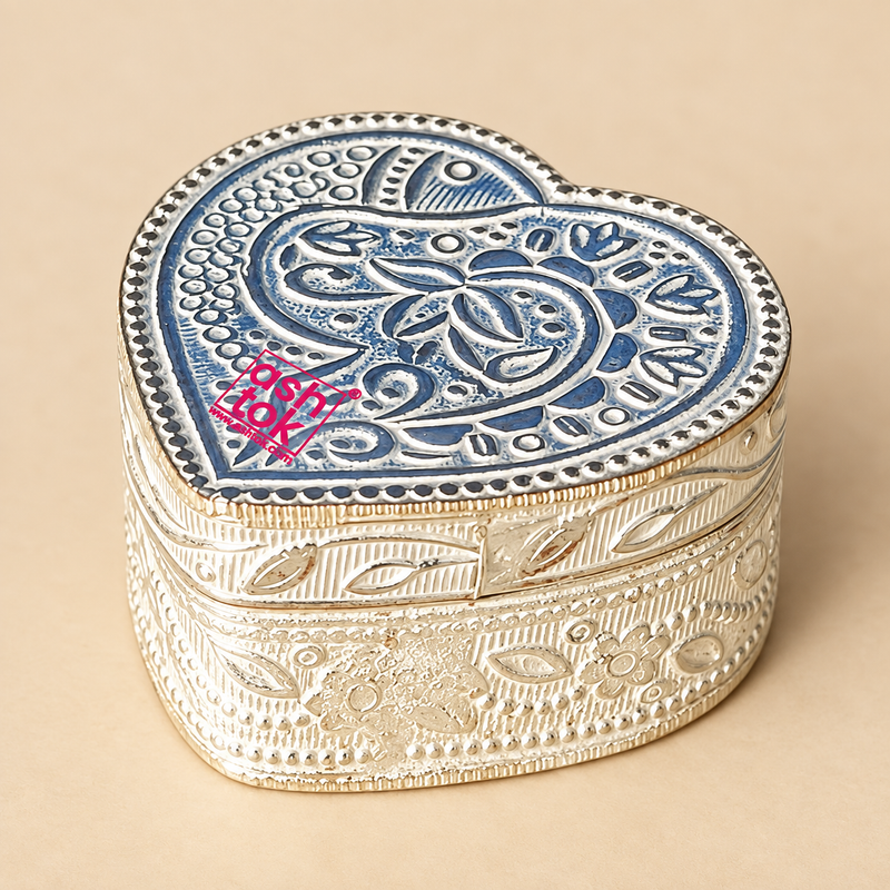 Heart-shaped German Silver Kumkum Box with a compact low-profile body, intricately engraved floral and paisley-style lid, decorative beaded border, detailed sidewall engraving and polished silver-tone finish, photographed as a clean main product image on a premium beige studio background, suitable for storing kumkum, roli, sindoor and other small pooja essentials, as well as for festive gifting, wedding return gifts, housewarming gifts and traditional Indian religious occasions.