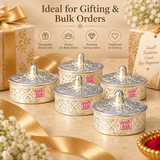 Multiple matching German Silver Kumkum Boxes arranged neatly in a premium festive gifting presentation with beige and gold gift styling, highlighting the engraved floral body, decorative lids with rounded knobs, polished silver finish and compact traditional design, suitable for wedding return gifts, housewarming gifts, festive giveaways, pooja favors, religious functions, corporate gifting, family celebrations and larger bulk order requirements.
