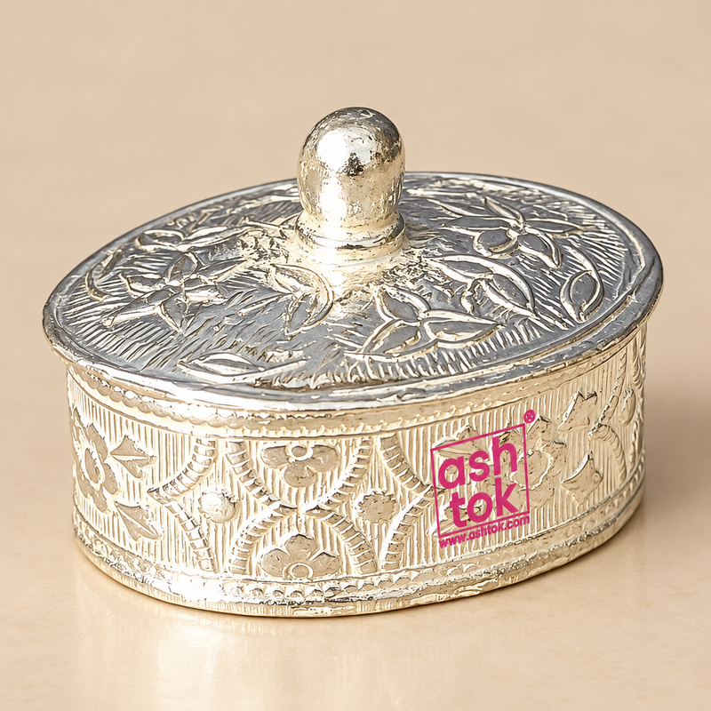 Traditional German Silver Kumkum Box with an ornate floral engraved cylindrical body, matching decorative lid, rounded top knob, detailed border work and polished silver finish, photographed as a clean front-facing product image on a premium beige studio background, showing the complete closed box clearly for use as a kumkum container, sindoor box, roli box, pooja accessory, festive decor item, wedding return gift, housewarming gift and traditional Indian gifting item.