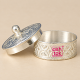 Open German Silver Kumkum Box with the decorative engraved lid placed beside the container, showing the smooth inner storage area, floral engraved outer body, polished silver finish, detailed border work and rounded lid knob, photographed on a clean beige studio background to demonstrate the usable interior and removable lid design for storing kumkum, sindoor, roli, turmeric or other small traditional pooja essentials.