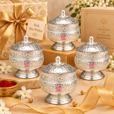 Multiple matching German Silver Kumkum Holders arranged neatly in a premium festive gifting presentation with elegant gift boxes, ribbons and floral accents, showcasing the rounded floral engraved bodies, domed decorative lids, polished silver finish and pedestal bases, suitable for wedding return gifts, housewarming favors, festive giveaways, pooja gifts, religious functions, family celebrations, corporate gifting and larger bulk order