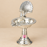diya-main.jpg	German Silver Peacock Diya with detailed peacock motif, polished silver finish, decorative diya bowl and sturdy pedestal base, suitable for pooja, Diwali decoration, festive occasions and traditional home decor