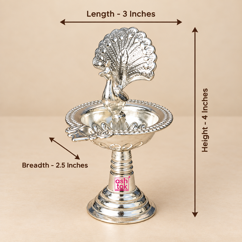 German Silver Peacock Diya size guide showing approximately 3 inches length, 2.5 inches breadth and 4 inches height with detailed peacock design, decorative bowl and pedestal stand