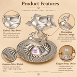 German Silver Pooja Diya features image highlighting the raised oil diya bowl, decorative peacock motif, detailed silver finish, textured circular base and traditional ornamental craftsmanship, designed as an elegant pooja accessory for home temples, festivals and gifting, with close detail views showing the patterned bowl border, peacock body detailing and embossed base design.