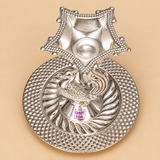 Top elevated view of a German Silver Pooja Diya showing the decorative square shaped oil bowl with beaded border, detailed peacock motif beneath the diya holder and circular embossed base with leaf inspired pattern and textured outer border, photographed on a clean beige background to clearly display the product construction for pooja, Diwali decoration, home temple use and festive gifting.