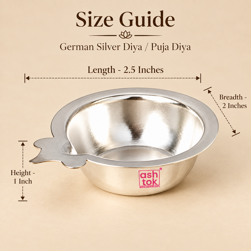 Size guide image of a German Silver Puja Diya showing approximately 2.5 inch length, 2 inch breadth and 1 inch height with clear measurement arrows, while displaying the polished silver bowl, wide flared rim, shallow body and side wick-holder extension on a premium beige background, helping customers understand the compact dimensions and proportions before purchase for daily pooja, home mandir use, festive rituals and gifting.