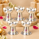 puja-diya-bulk-gifting-set.jpg	Multiple German Silver Puja Diyas arranged together for bulk gifting, wedding return gifts, festive giveaways, housewarming presents, pooja gifts and religious event gifting, each featuring a polished silver finish, lotus petal shaped bowl, compact pedestal and broad stable base