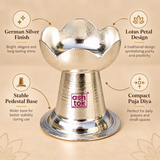 German Silver Puja Diya features image highlighting the bright polished silver finish, lotus petal shaped diya bowl, compact traditional form, stable pedestal base and elegant decorative appearance, making it suitable for daily prayers, home temple use, Diwali, Navratri, weddings and festive ceremonies