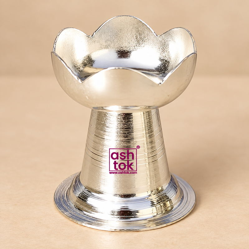 German Silver Puja Diya with elegant lotus petal shaped bowl, polished reflective silver finish, compact pedestal body and broad circular base, designed for daily pooja, festive rituals, Diwali decoration, home mandir use, religious ceremonies, wedding functions, housewarming occasions and traditional gifting