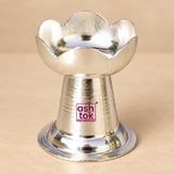 German Silver Puja Diya with elegant lotus petal shaped bowl, polished reflective silver finish, compact pedestal body and broad circular base, designed for daily pooja, festive rituals, Diwali decoration, home mandir use, religious ceremonies, wedding functions, housewarming occasions and traditional gifting