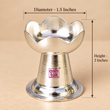 German Silver Puja Diya size guide showing approximately 1.5 inch diameter and 2 inch height, featuring a lotus petal inspired upper bowl, polished silver finish, compact tapered pedestal and stable circular base suitable for pooja, festive decoration, religious rituals and gifting