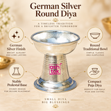 German Silver Round Diya features image highlighting the polished German silver finish, traditional round bowl design, sturdy pedestal base, compact size and elegant appearance, making it suitable for daily pooja, home temple decoration, Diwali celebrations, festive rituals, religious ceremonies and gifting