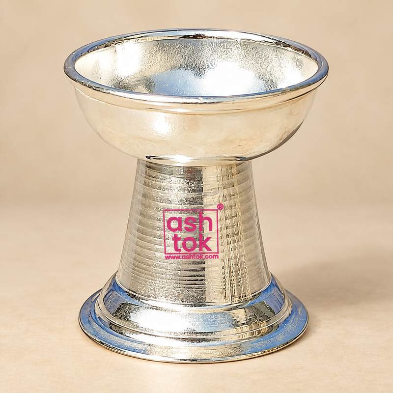 German Silver Round Diya with a traditional circular oil lamp bowl, smooth raised rim, polished reflective silver finish, tapered pedestal body and broad stable round base, suitable for daily pooja, home mandir use, Diwali lighting, festive decoration, religious rituals, wedding ceremonies, housewarming functions, traditional gifting and decorative pooja arrangements
