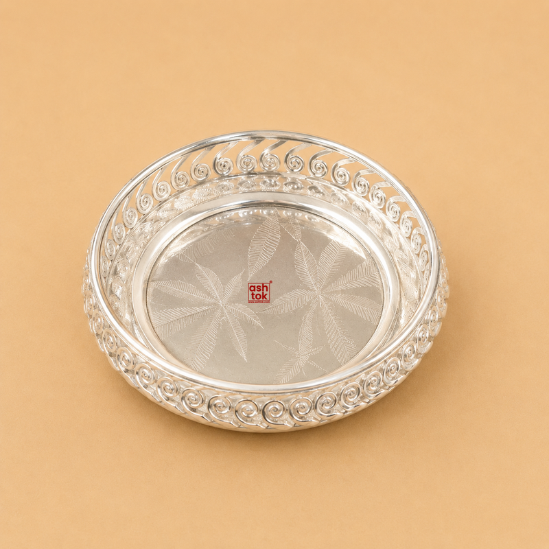 Handcrafted German Silver round serving bowl with spiral cutwork border and engraved floral base, ideal for serving sweets, dry fruits, chocolates, fruits, gifting, pooja, and home décor.