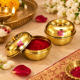 Lifestyle image of the brass sindoor box styled in a festive pooja-inspired setting on a beige background, showing how the small brass container can be used as a traditional gift item, chocolate box, or sindoor storage container.