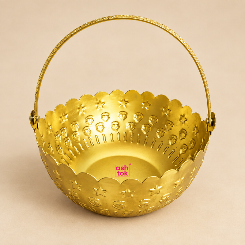 Gold coated flower gift basket with a round bowl shape, decorative scalloped rim, embossed star and floral pattern, and a tall curved carrying handle, professionally presented on a premium beige studio background for gifting, flower presentation and home decor.