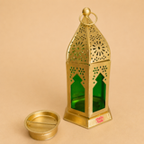 Gold metal decorative lantern with green glass panels and matching tealight holder, featuring intricate cutout detailing for home décor, Ramadan, Diwali, weddings, and festive candle displays.