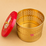 Open decorative golden metal storage box with laser-cut pattern and red cow design lid, ideal for return gifts, dry fruit storage, festive gifting, and home decor by Ashtok.