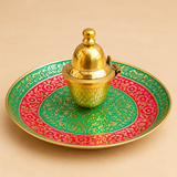 Meenakari kumkum box with matching decorative plate displayed inside an open red presentation box on a beige background