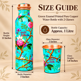 Size guide image of a green enamel printed pure copper water bottle with matching drinking glass. The bottle has a capacity of 1 litre, diameter of 3 inches and height of 11 inches. The matching glass measures 3 inches in diameter and 3.8 inches in height. Both products feature a turquoise-green floral exterior with pink blossoms and polished copper accents.