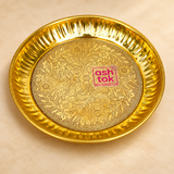 Handcrafted brass puja plate with intricate floral engraving, polished golden finish and decorative fluted raised rim, presented on a premium beige studio background for pooja, mandir and traditional ceremonial use.