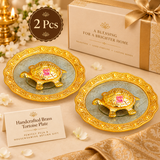 Set of 2 Handcrafted Brass Tortoise Plates displayed together in an elegant gifting presentation with decorative gift packaging on a premium beige background. Each piece features a detailed golden brass tortoise mounted on an ornate embossed plate, making this set suitable for return gifts, housewarming presents, festive gifting, wedding favors and traditional gift collections.